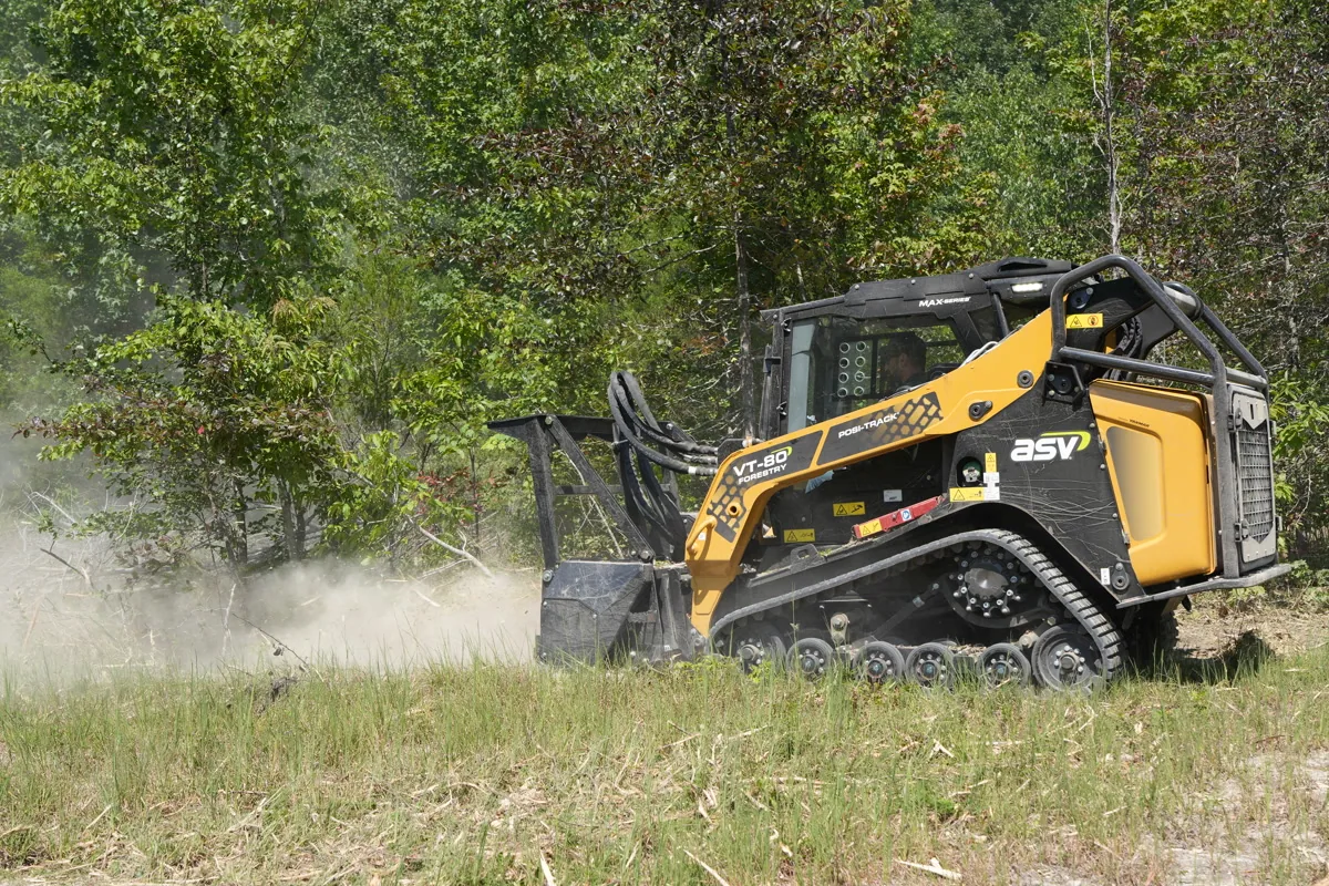 Clear Path mulcher actively clearing dense brush and overgrowth in an open field on a Middle Tennessee property